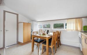 a kitchen with a table and chairs in a room at 2 Bedroom Nice Apartment In Ringkøbing in Ringkøbing +11 photos