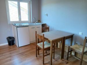 a kitchen with a table and chairs and a sink at Hôtel de Cenves in Cenves