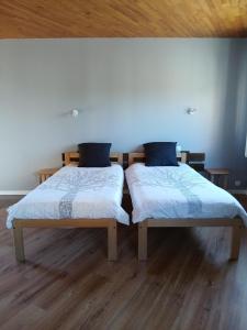 two beds sitting next to each other in a room at Hôtel de Cenves in Cenves
