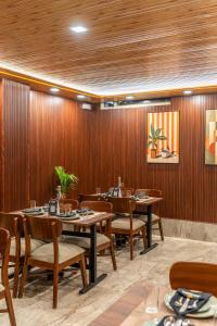 a restaurant with wooden walls and tables and chairs at Perfectstayz AIIMS near Aiims Hospital in Rishīkesh