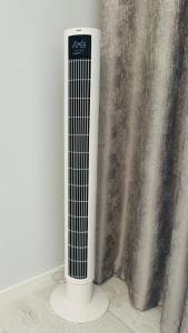a white radiator sitting next to a curtain at Апартаменти La Storia in Kamianets-Podilskyi