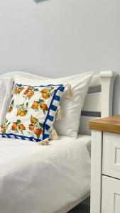 a white bed with a pillow on it at Апартаменти La Storia in Kamianets-Podilskyi