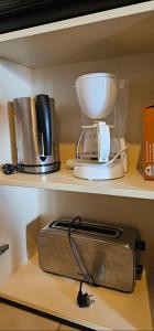 a kitchen shelf with a mixer and a blender at LES BALCONS DE LA CHIUSA in Vico +37 photos