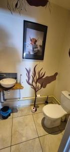 a bathroom with a toilet and a sink at L'Esprit Zen #air conditioning #spa in Nercillac