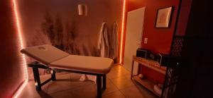 a bathroom with a chair in a room with a mirror at L'Esprit Zen #air conditioning #spa in Nercillac +2 photos