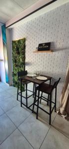 a table and two chairs and a sign on a wall at L'Esprit Zen #air conditioning #spa in Nercillac