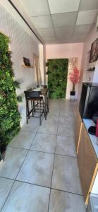 a patio with a table and chairs in a room at L'Esprit Zen #air conditioning #spa in Nercillac