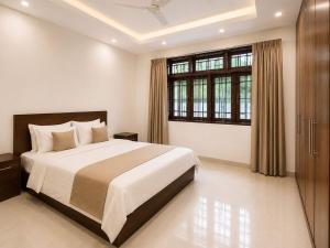 a bedroom with a large bed and a large window at Crescent Villa in Kalutara
