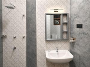 a bathroom with a sink and a mirror at Crescent Villa in Kalutara