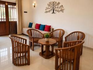 a living room with a couch and a table and chairs at Crescent Villa in Kalutara