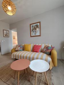 a living room with a couch and two tables at le maquis in Sisco