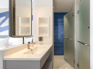 a bathroom with a sink and a mirror at Bedz Hotel Ban Bueng in Ban Bung +18 photos
