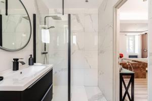 a bathroom with a sink and a shower at L'Eden Spa - Jacuzzi - Saint-Etienne in Saint-Étienne
