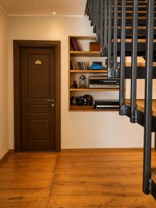 a room with a door and a staircase with wooden floors at Chemodann Kazbegi in Kazbegi +142 photos