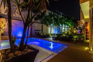 a house with a swimming pool at night at Afrin Prestige Hotel in Maputo