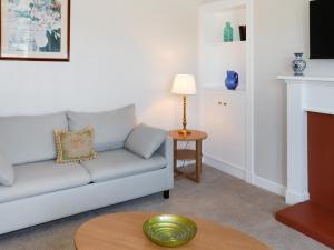 a living room with a couch and a table at Rose Cottage - Uk52178 in Leven