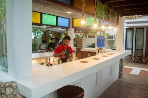 a man standing at a counter in a restaurant at Katunggan Cove Resort in Nueva Valencia +42 photos
