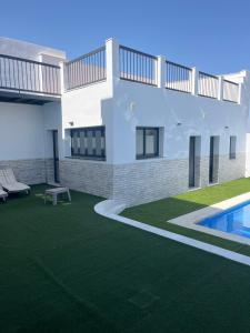 a rendering of a house with a lawn and a swimming pool at Pozo, 22 in Fuente Palmera