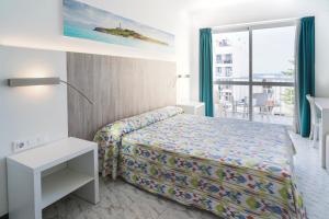 a hotel room with a bed and a balcony at Hotel Amic Can Pastilla in Can Pastilla +44 photos