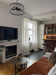a living room with a couch and a tv at Podróżnik in Oświęcim