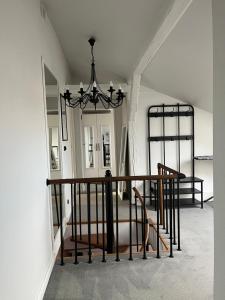 a room with a chandelier and a mirror at Podróżnik in Oświęcim +39 photos