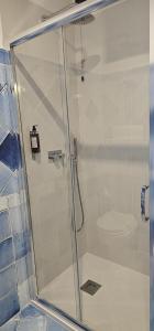 a shower with a glass door in a bathroom at Hotel Corallo Sperlonga in Sperlonga +65 photos