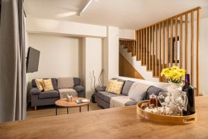 a living room with a couch and a table at Alestone Villa by the sea in Vasilikos