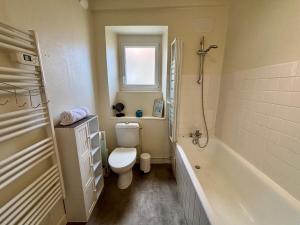 a bathroom with a toilet and a tub and a sink at Samour House - Centre ville in Saint-Vaast-la-Hougue +18 photos