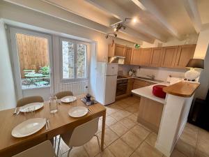 a kitchen with a table with chairs and a dining room at Samour House - Centre ville in Saint-Vaast-la-Hougue