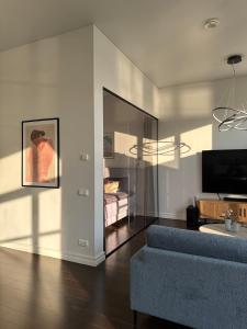 a living room with a couch and a bedroom at Tamula Panorama in Võru