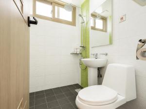 a bathroom with a toilet and a sink at 오후여섯시펜션 in Jeju