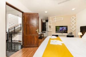 a bedroom with a bed and a living room at Villa Oasis in Kataragama
