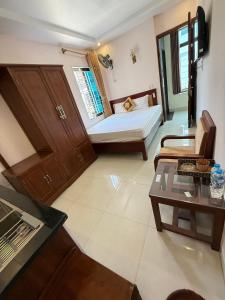 a room with a bed and a couch and a table at LD Housing 9 in Ðống Thôn