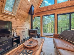 a living room with a couch and a television in a cabin at Stunning New Construction Modern Beautiful in McHenry