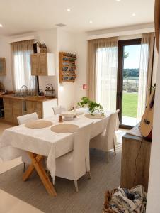 a kitchen and dining room with a table and chairs at Exclusive Olive & Herb Villa, Mountain to Sea Views, Rhodes in Afantou +47 photos