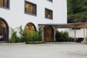 a building with two doors and a patio at Hotel Yadu Vilas in Phata