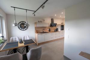 a kitchen and dining room with a table and chairs at Ferienwohnnung EifelPanorama Berk in Dahlem