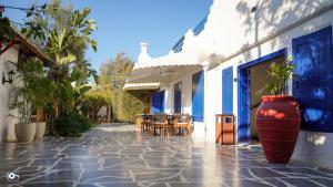 a courtyard of a building with tables and chairs at IOS Village & Hotels in El Alamein
