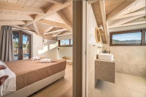 a bedroom in a house with a bed and a sink at Alestone Villa by the sea in Vasilikos +33 photos