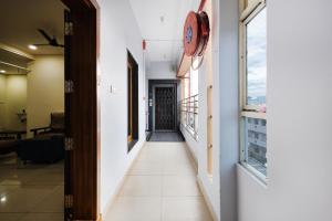 a corridor in a building with a clock on the wall at Sapthami Luxury Rooms in Guntūr