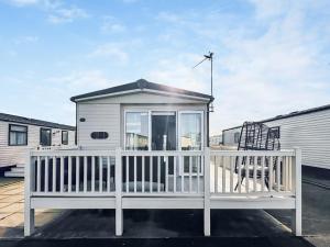a small house with a white railing on a deck at Abi St David - Ukc9615 in Rowen
