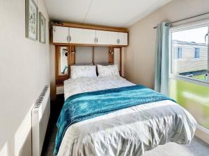 a bedroom with a large bed and a window at Abi St David - Ukc9615 in Rowen