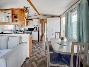 a living room and kitchen with a table and a couch at Abi St David - Ukc9615 in Rowen