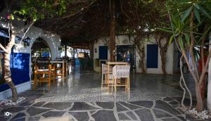 a restaurant with chairs and tables and trees at IOS Village & Hotels in El Alamein
