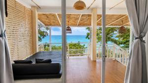 a view of the ocean from the living room of a house at Moonlight Bay Resort in Ko Lanta