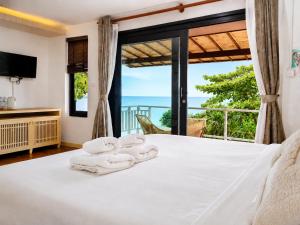 a bedroom with a bed and a large window at Moonlight Bay Resort in Ko Lanta