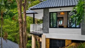 a house with a view of the trees at Moonlight Bay Resort in Ko Lanta +13 photos