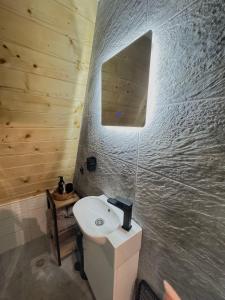 a bathroom with a white sink and a mirror at Forest Whisper - Mountain Retreat in Kovačka Dolina