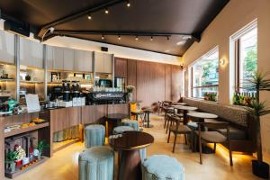 a restaurant with tables and chairs and a bar at Arun Sa Wad 103 NaNa in Bangkok