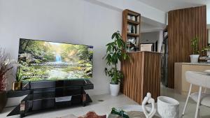 a living room with a flat screen tv on a wall at VFeel at Home- 2 BR Unit in Baguio +9 photos